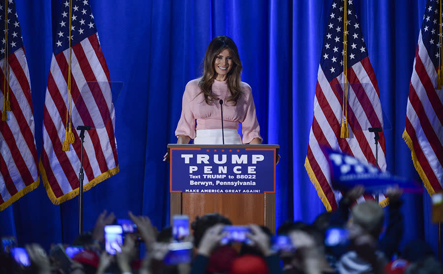 Melania Trump delivering a speech at a rally on November 3, 2016 wearing a pink top with a white pencil skirt