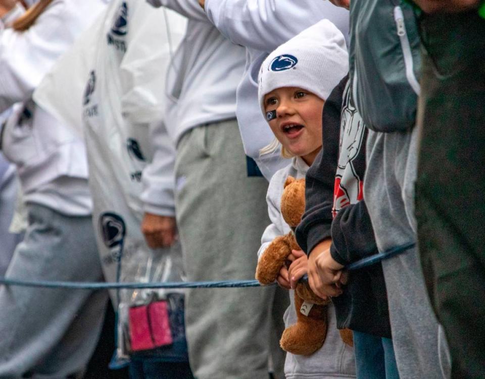 Fans cheer for the football team to arrive at Beaver Stadium on Saturday, Sept. 23, 2023.