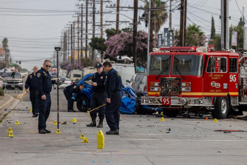 WEST RANCH DOMINGUEZ, CA - SEPTEMBER 05: Multidisciplinary Accident Investigation Team at the scene of a double fatal crash involving a Los Angeles County fire truck and sedan at the intersection of South Avalon Boulevard and East Compton Boulevard in West Ranch Dominguez, CA. (Irfan Khan / Los Angeles Times)