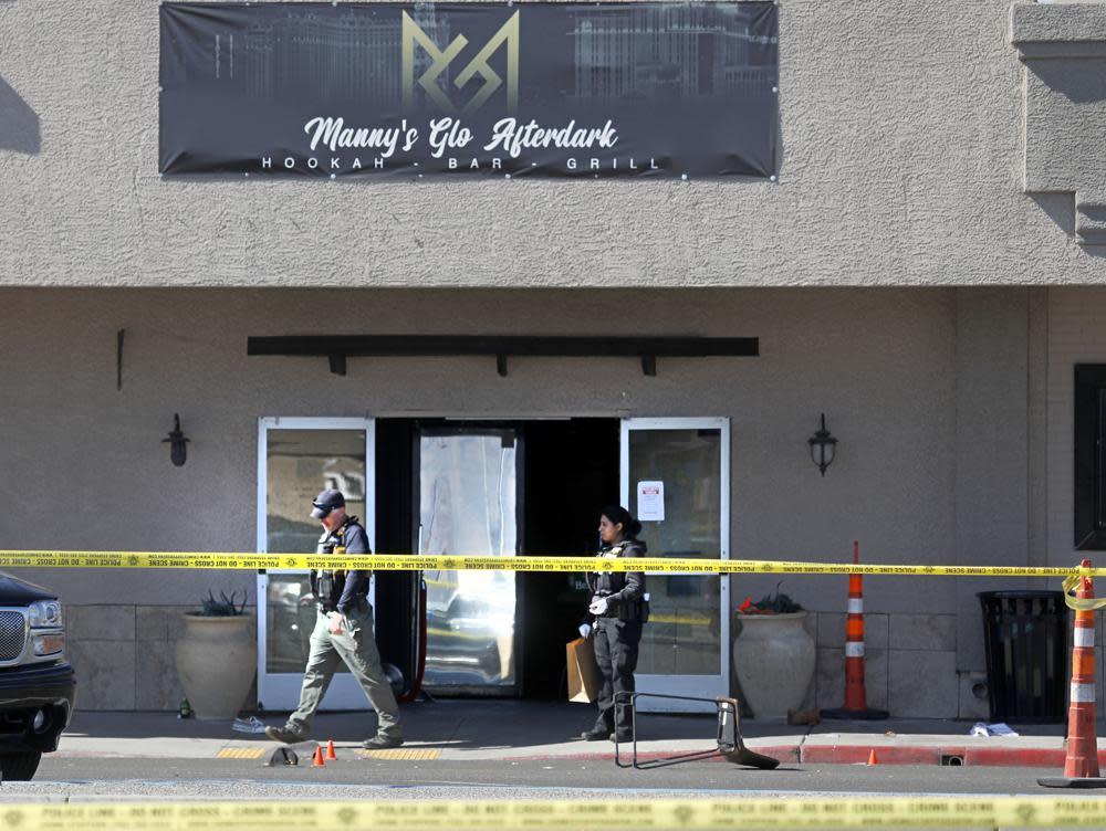 Las Vegas police investigate at Manny’s Glow Ultra Lounge & Restaurant, after a shooting, Saturday, Feb. 26, 2022, in Las Vegas. Multiple people were shot before dawn Saturday morning at a hookah parlor. (Chitose Suzuki/Las Vegas Review-Journal via AP)