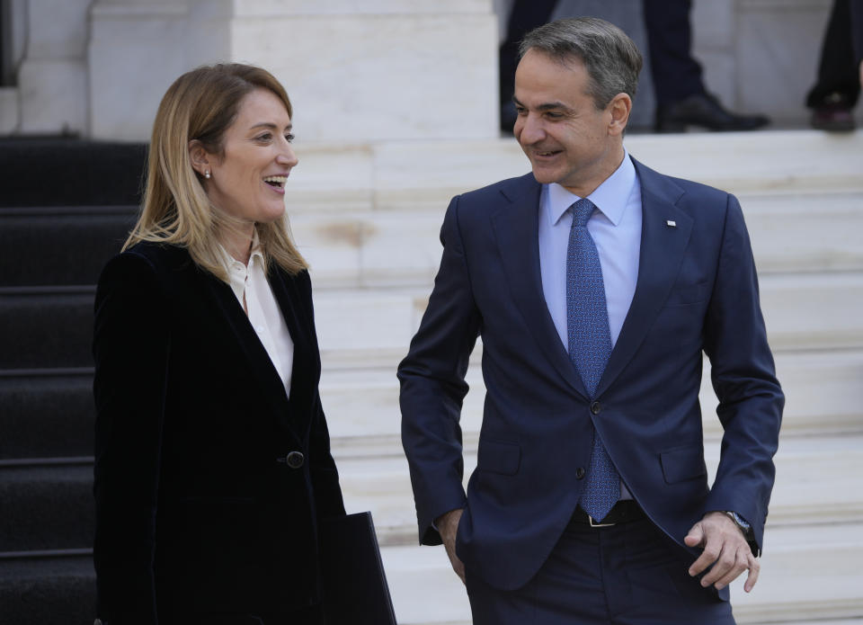 Greece's Prime Minister Kyriakos Mitsotakis, right, speaks with European Parliament President Roberta Metsola after their meeting at Maximos Mansion in Athens, Greece, Tuesday, Feb. 20, 2024. Metsola is in Athens on Tuesday, as part of her campaign to raise awareness and encourage people to vote in the European Parliament elections in June. (AP Photo/Thanassis Stavrakis)