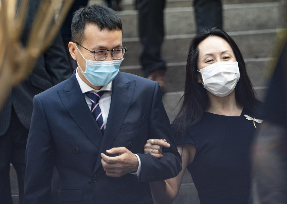 Meng Wanzhou, right, chief financial officer of Huawei, leaves for a lunch break during her extradition hearing at British Columbia Supreme Court Friday, Aug. 13, 2021 in Vancouver, British Columbia. (Jimmy Jeong/The Canadian Press via AP)