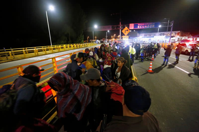 FILE PHOTO: Stranded migrants are pictured at Rumichaca International Bridge between Colombia and Ecuador, after Ecuador's government closed its borders to all foreign travelers due to the spread of the coronavirus disease (COVID-19), in Tulcan