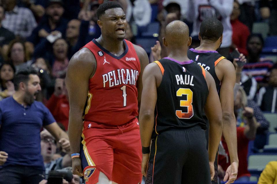 New Orleans Pelicans forward Zion Williamson (1) yells at Phoenix Suns guard Chris Paul (3) after a slam dunk in the first half of an NBA basketball game in New Orleans, Friday, Dec. 9, 2022. (AP Photo/Matthew Hinton)