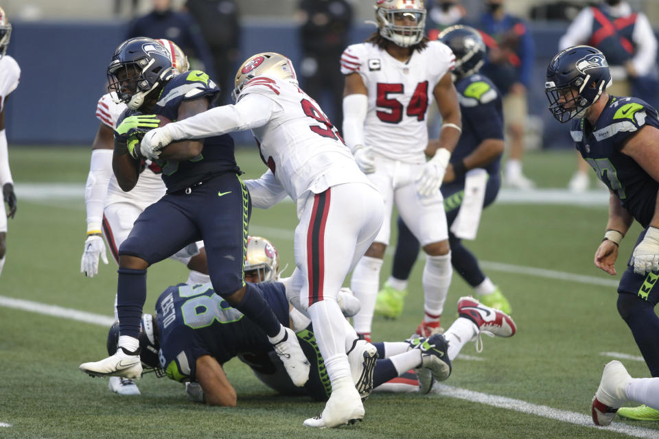 Seattle Seahawks running back DeeJay Dallas, left, scores a touchdown against the San Francisco 49ers during the second half of an NFL football game, Sunday, Nov. 1, 2020, in Seattle. The Seahawks won 37-27. (AP Photo/Scott Eklund)