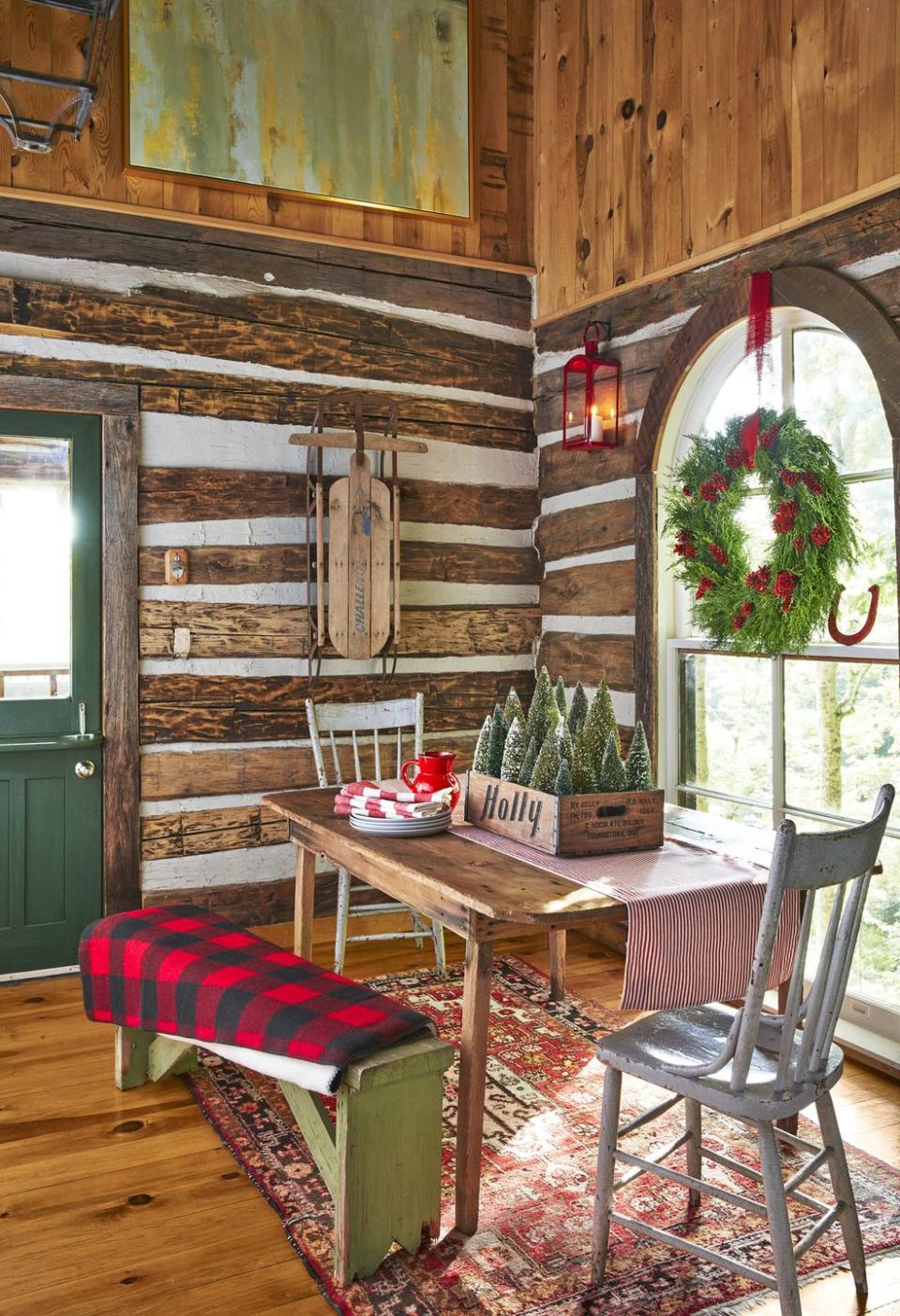 <p>With this reclaimed centerpiece, a 1960s Holly Beverage Co. soda crate filled with bottle brush trees adds a touch of festive cheer to the dining nook. The area is furnished with an antique table—which was actually bought at the <em>Country Living</em> Fair! </p><p><a class="link " href="https://www.amazon.com/DearHouse-Artificial-Christmas-Bottle-Ornaments/dp/B09G6FVCT9/ref=sr_1_2?crid=1HBLEFQ889IY9&keywords=green%2Bbottle%2Bbrush%2Btrees&qid=1669154821&sprefix=green%2Bbottle%2Bbrush%2Btree%2Caps%2C139&sr=8-2&th=1&tag=syn-yahoo-20&ascsubtag=%5Bartid%7C10050.g.644%5Bsrc%7Cyahoo-us" rel="nofollow noopener" target="_blank" data-ylk="slk:Shop Now;elm:context_link;itc:0;sec:content-canvas">Shop Now</a></p>