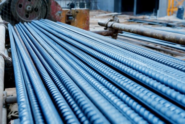 Artistic steel bars closeup, reinforcement on construction site, editable background. Steel bars or rods used on construction sites for concrete layering.