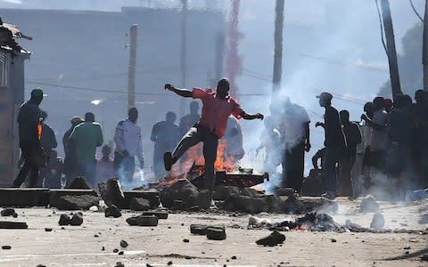 Opposition supporters block a road and burn tyres during clashes with riot police in Mathare slums in Nairobi, Kenya, Monday - Credit: Brian Inganga/ AP