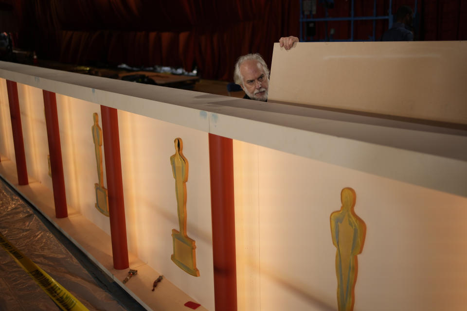 A worker assembles a backdrop along the carpet during preparations for Sunday's 95th Academy Awards, Friday, March 10, 2023, in Los Angeles. (AP Photo/John Locher)