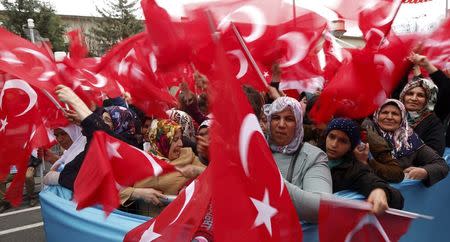 Supporters of Turkish President Tayyip Erdogan wave Turkey's national flags as they wait for the start of a rally for the upcoming referendum in the Kurdish-dominated southeastern city of Diyarbakir, Turkey, April 1, 2017. REUTERS/Murad Sezer