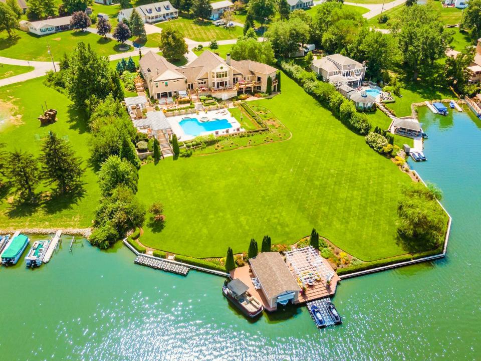 A Choctaw Lake home listed for $2.85 million features an expansive lawn leading to a boathouse and dock.