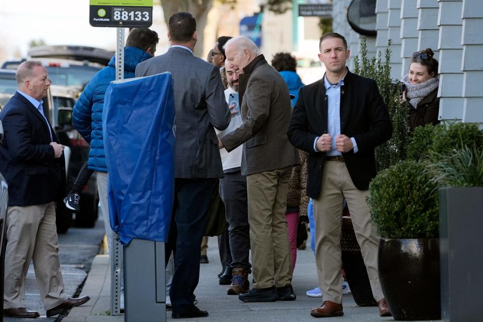 President Joe Biden, center, greets people outside the Henlopen City Oyster House while having lunch at the restaurant in Rehoboth Beach, Del., Saturday, Feb. 17, 2024.