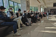 Family members of the deceased wait for the cremation procedures at a funeral home in Shanghai, China on Jan. 4, 2023. China on Saturday, Jan. 14, reported nearly 60,000 deaths in people who had COVID-19 since early December following complaints the government was failing to release data about the status of the pandemic. (Chinatopix Via AP)