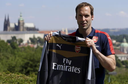 Czech soccer player Petr Cech shows his Arsenal jersey during a presentation in Prague July 1, 2015. Arsenal have arranged to sign Czech goalkeeper from Chelsea on Monday, according to the Arsenal soccer club. REUTERS/David W Cerny