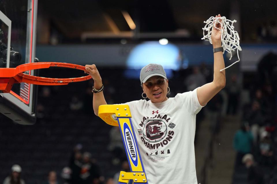 Dawn Staley cuts down the net after her South Carolina Gamecocks won the 2022 national championship.