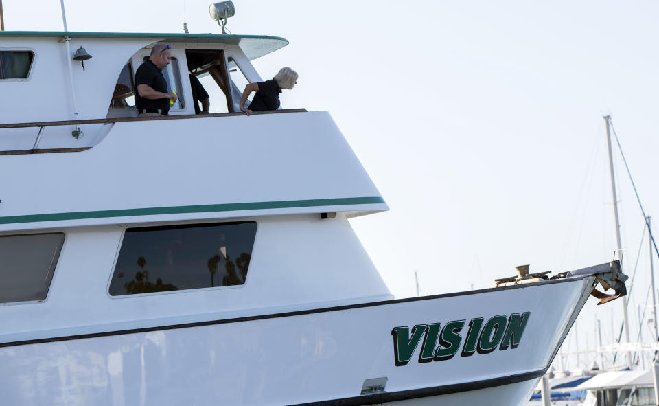 National Transportation Safety Board member Jennifer Homendy, right, and Investigator In Charge Adam Tucker inspect the Vision, aa sister vessel to the dive boat Conception, at Santa Barbara Harbor on Wednesday, Sept. 4, 2019 in Santa Barbara, Calif. A fire raged through a boat carrying recreational scuba divers anchored near an island off the Southern California Coast on Monday, Sept. 2, leaving multiple people dead. (AP Photo/Christian Monterrosa )