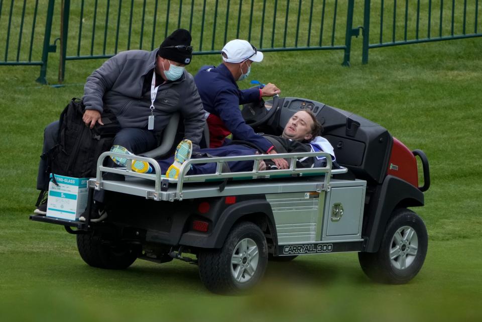 Actor Tom Felton is helped after collapsing on the 18th hole during a practice day at the Ryder Cup at the Whistling Straits Golf Course Thursday, Sept. 23, 2021, in Sheboygan, Wis.