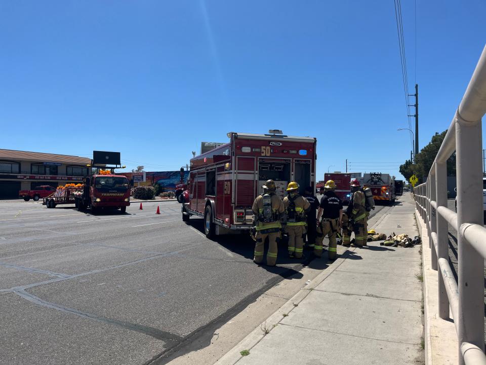 Firefighters and road crews block Northern Avenue just off Interstate 17 in Phoenix on April 15, 2024, after a car crashed into a gas main, causing an evacuation of the nearby area.