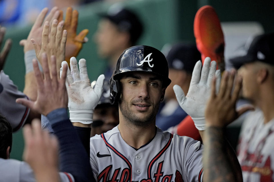 Atlanta Braves' Matt Olson celebrates in the dugout after hitting a solo home run during the first inning of a baseball game against the Kansas City Royals Friday, April 14, 2023, in Kansas City, Mo. (AP Photo/Charlie Riedel)