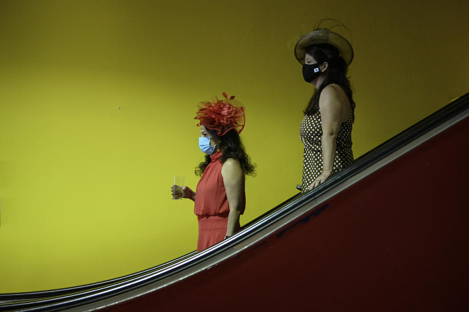Women wear hats during the Preakness Stakes horse race at Pimlico Race Course, Saturday, May 15, 2021, in Baltimore. (AP Photo/Nick Wass)