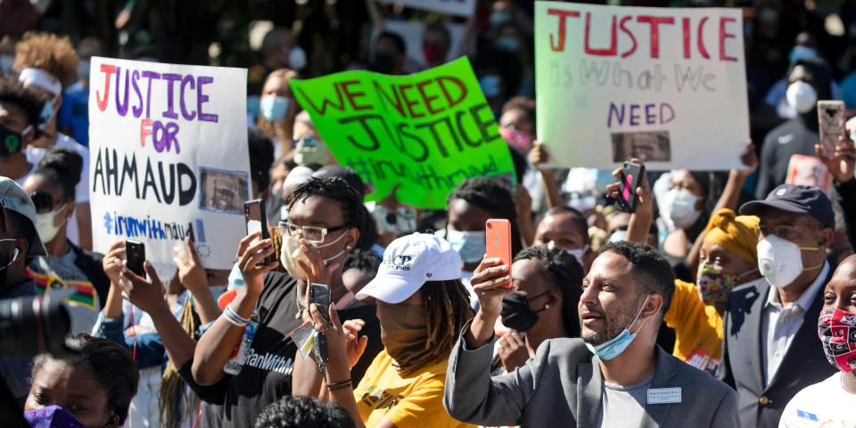 People react during a rally to protest the shooting of Ahmaud Arbery, Friday, May 8, 2020, in Brunswick Ga.