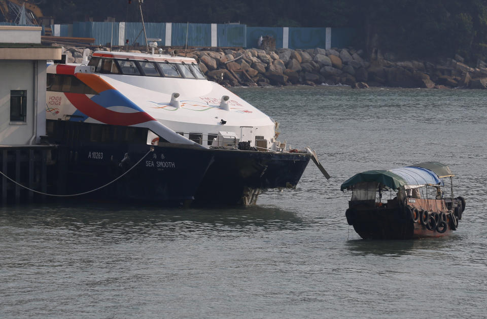 A damaged ferry is docked at a pier after colliding with a boat in Lamma Island, off the southwestern coast of Hong Kong Tuesday, Oct. 2, 2012. The ferry on Monday collided with a boat owned by utility company Power Assets Holdings Ltd., which was taking its workers and their families to famed Victoria Harbor to watch a fireworks display in celebration of China's National Day and mid-autumn festival, killing at least 36 people. (AP Photo/Kin Cheung)