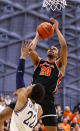 Princeton forward Tosan Evbuomwan (20) drives to the basket against Yale forward Matt Knowling (22) during the first half of the Ivy League championship NCAA college basketball game, Sunday, March 12, 2023, in Princeton, N.J. (AP Photo/Noah K. Murray)