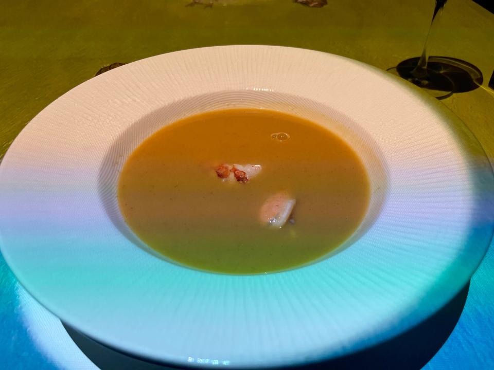 White bowl of seafood bisque at Le Petit Chef