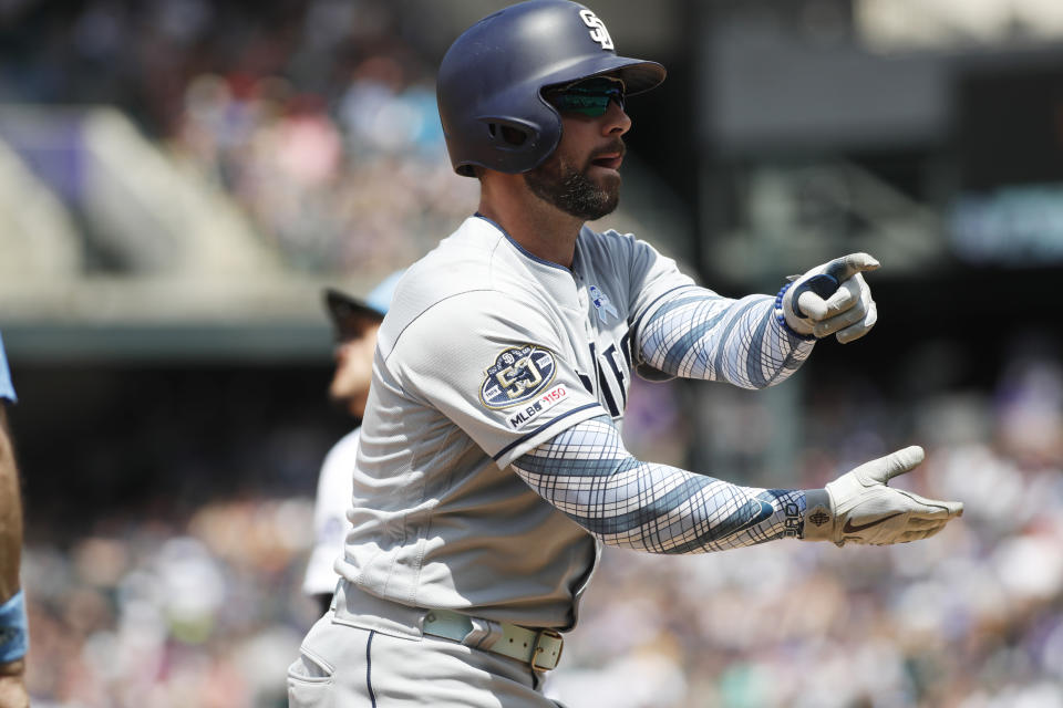 San Diego Padres' Greg Garcia gestures to the dugout after hitting a triple to drive in two runs off Colorado Rockies starting pitcher Peter Lambert in the third inning of a baseball game Sunday, June 16, 2019, in Denver. (AP Photo/David Zalubowski)