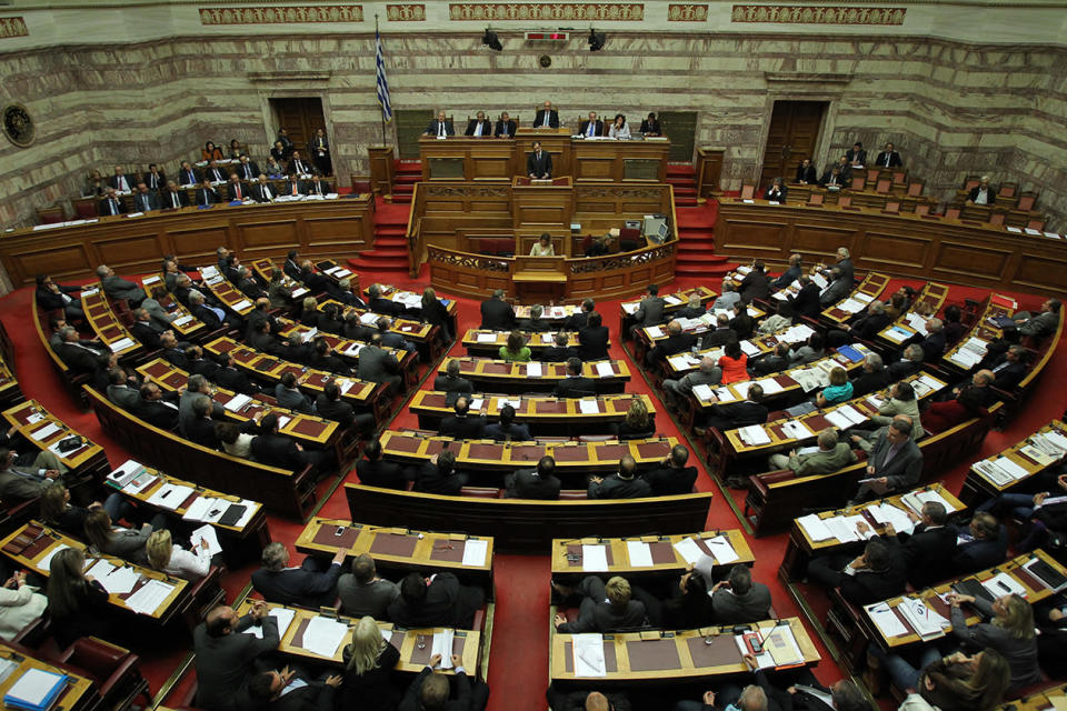 Greece's Prime Minister Antonis Samaras, centre rear, delivers a speech during a vote for the new austerity measures at the Greek parliament in Athens.