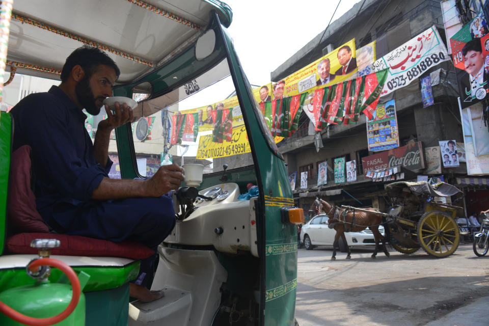 A Pakistani auto rickshaw driver sips tea on a street corner in the old city, in Lahore, Pakistan, in a May 10, 2013 file photo. / Credit: ROBERTO SCHMIDT/AFP/Getty