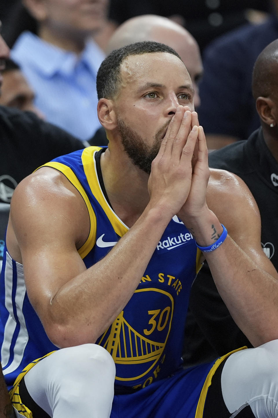 Golden State Warriors guard Stephen Curry sits on the bench during the second half of the team's NBA basketball play-in tournament game against the Sacramento Kings, Tuesday, April 16, 2024, in Sacramento, Calif. (AP Photo/Godofredo A. Vásquez)