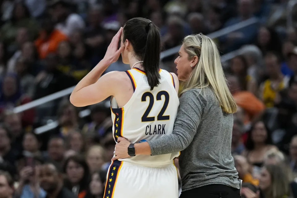 Indiana Fever guard Caitlin Clark (22) is greeted by coach Christie Sides after a foul during the first half of the team's WNBA basketball game against the Los Angeles Sparks in Los Angeles, Friday, May 24, 2024. (AP Photo/Ashley Landis)