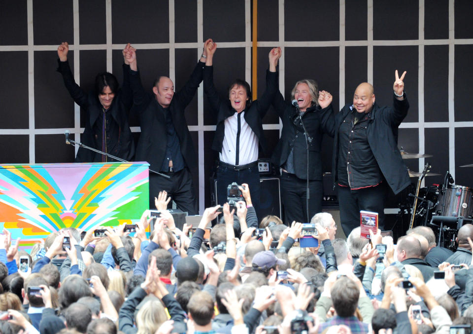 Paul McCartney and his band give a surprise pop up concert in Times Square on Thursday, Oct. 10, 2013 in New York. McCartney will release his new album called "New" on October 15. (Photo by Evan Agostini/Invision/AP)