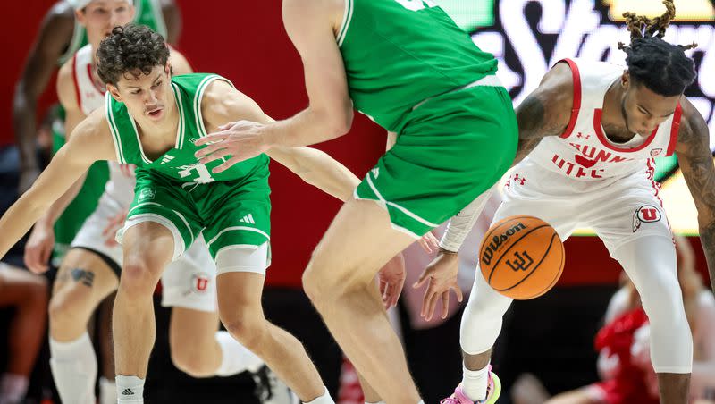 Utah Utes guard Deivon Smith (5) strips the ball from Utah Valley Wolverines guard Drake Allen (3) at the Huntsman Center in Salt Lake City on Saturday, Dec. 16, 2023.