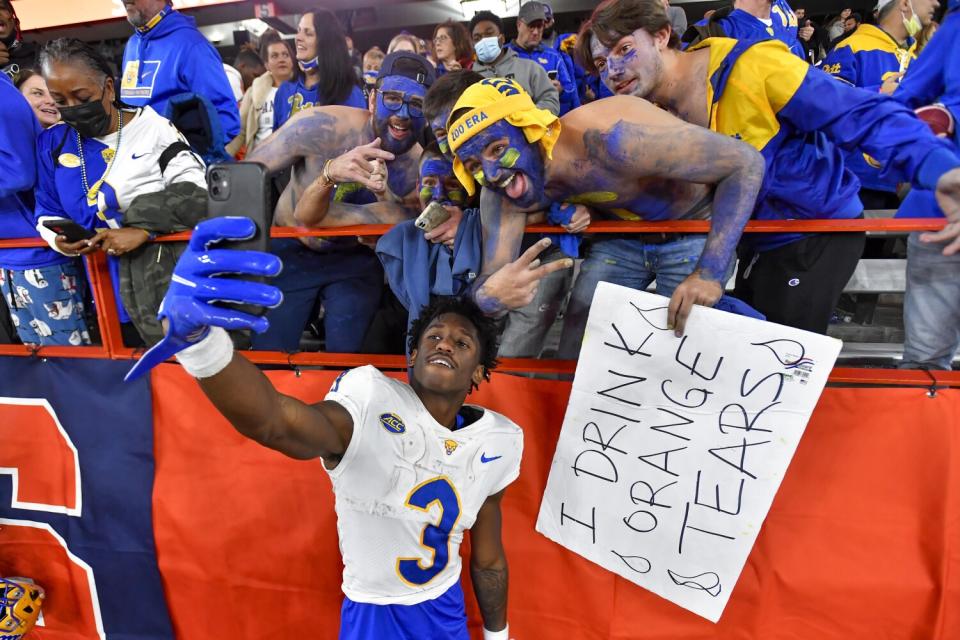 Jordan Addison takes a selfie with Pittsburgh fans after a win over Syracuse in November.