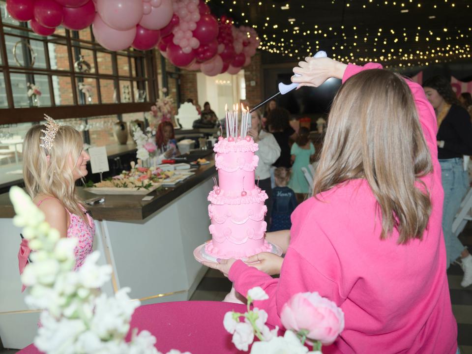 Evelyn blows out 13 candles atop an all-pink, red velvet cake.