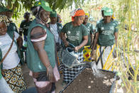 Mariama Sonko and other members of the "Nous Sommes la Solution" movement take part in a lemon balm pecking workshop in the Casamance village of Niaguis, Senegal, Wednesday, March 7, 2024. This quiet village in Senegal is the headquarters of a 115,000-strong rural women's rights movement in West Africa, We Are the Solution. Sonko, its president, is training female farmers from cultures where women are often excluded from ownership of the land they work so closely. (AP Photo/Sylvain Cherkaoui)