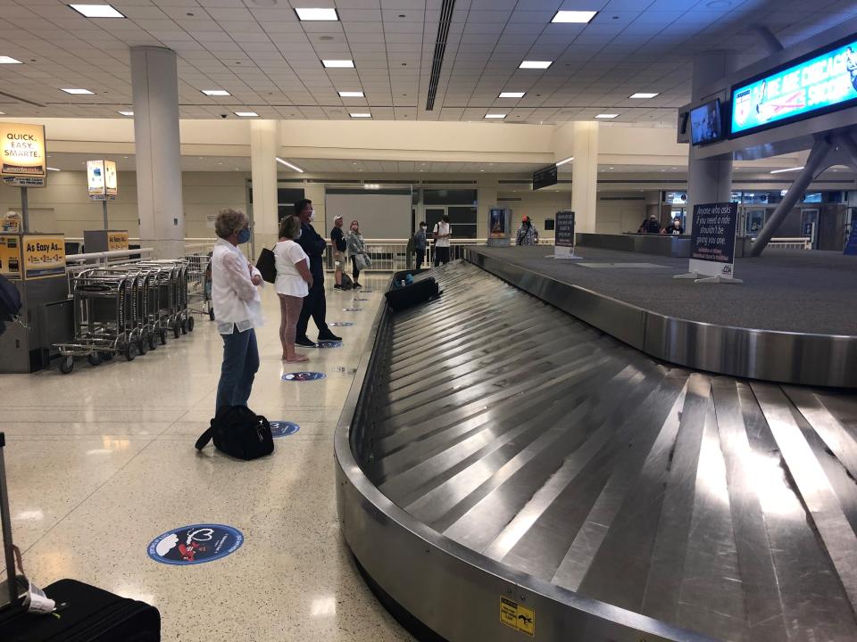 The Southwest Airlines baggage carousel at Midway International Airport in Chicago has social distancing markers on the floor for passengers to stand on as they wait for their bags.