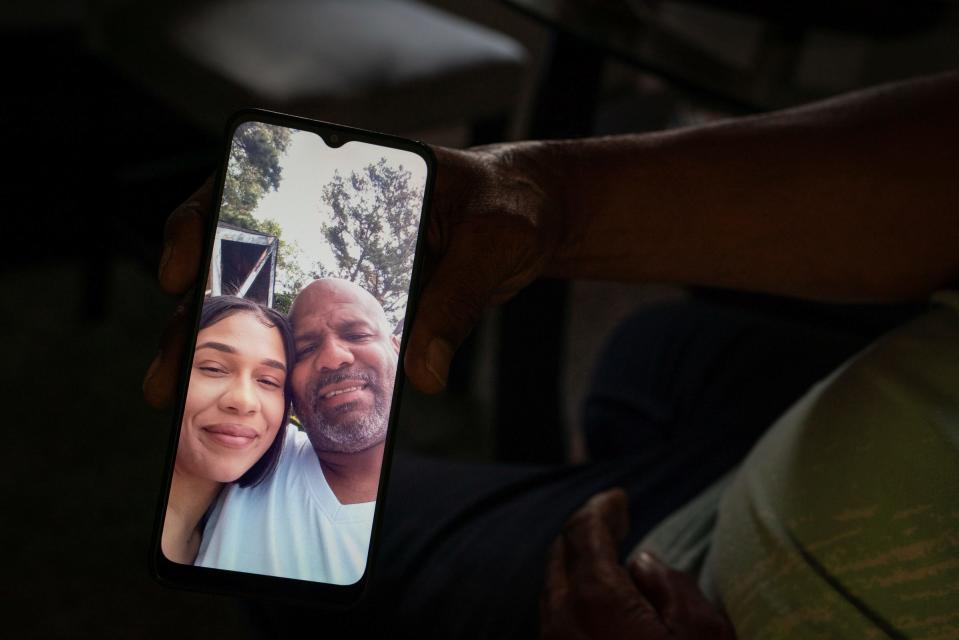 Marsay Dunlap, 49, shows a photograph of him and his daughter, Marlayna Dunlap, 26, who is three months pregnant, at his home in Detroit on Thursday, July 21, 2022. Dunlap's mother, Theresa Dunlap, 66, has stage 4 terminal cancer and has been in prison for 46 years for murder. u0022My mother has a loving family out here that loves her and has her back,u0022 said Marsay Dunlap. u0022She needs to be able to live the rest of her life out here.u0022