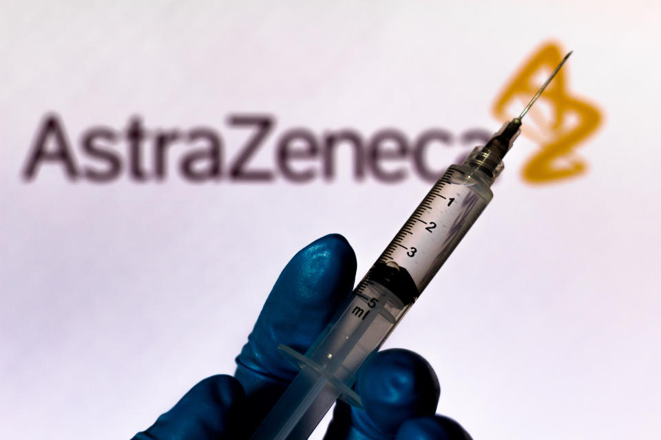 BRAZIL - 2020/10/04: In this photo illustration a medical syringe is seen with AstraZeneca company logo displayed on a screen in the background. (Photo Illustration by Rafael Henrique/SOPA Images/LightRocket via Getty Images)