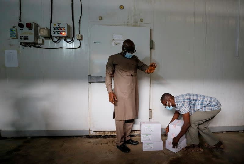 FILE PHOTO: A worker prepares to store boxes of vaccines in a cold room as the country receives its first batch of coronavirus disease (COVID-19) vaccines under COVAX scheme, in Accra