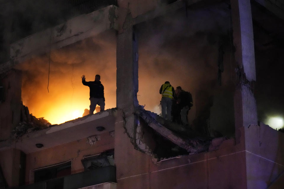 Civil defense workers search for survivors inside an apartment following a massive explosion in the southern suburb of Beirut, Lebanon, Tuesday, Jan. 2, 2024. The TV station of Lebanon's Hezbollah group says top Hamas official Saleh Arouri was killed Tuesday in an explosion in a southern Beirut suburb.(AP Photo/Hussein Malla)