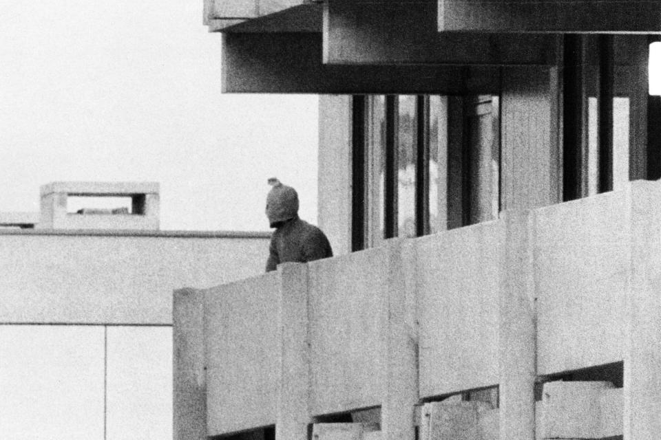 FILE - On Sept. 5, 1972, a Palestinian commando group seizes the Israeli Olympic team quarters at the Olympic Village in Munich, Germany. A member of the commando group is seen here as he appears with a hood over his face on the balcony of the building, where they hold several Israeli athletes hostage. (AP Photo/Kur Stumpf, File)