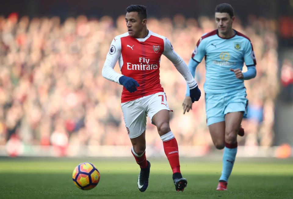 <p>Alexis Sanchez takes the ball on during the Premier League clash with Burnley </p>