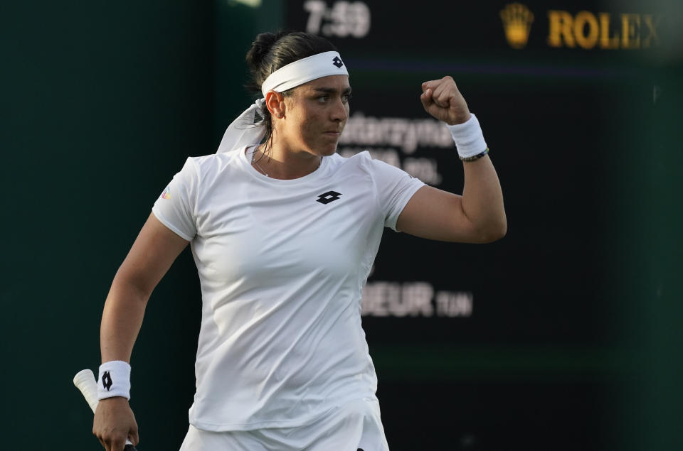 Tunisia's Ons Jabeur celebrates winning a point from Poland's Katarzyna Kawa in a second round women's singles match on day three of the Wimbledon tennis championships in London, Wednesday June 29, 2022. (AP Photo/Alberto Pezzali)