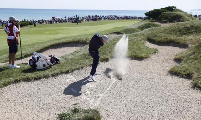 Xander Schauffele, who won both his matches on Friday, hits out of a bunker on the second.