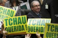 President of the Chamber of Deputies Eduardo Cunha observes congressmen, who support the impeachment, demonstrate during a session to review the request for Brazilian President Dilma Rousseff's impeachment, at the Chamber of Deputies in Brasilia, Brazil April 16, 2016. The placards read "Bye Dear". REUTERS/Ueslei Marcelino