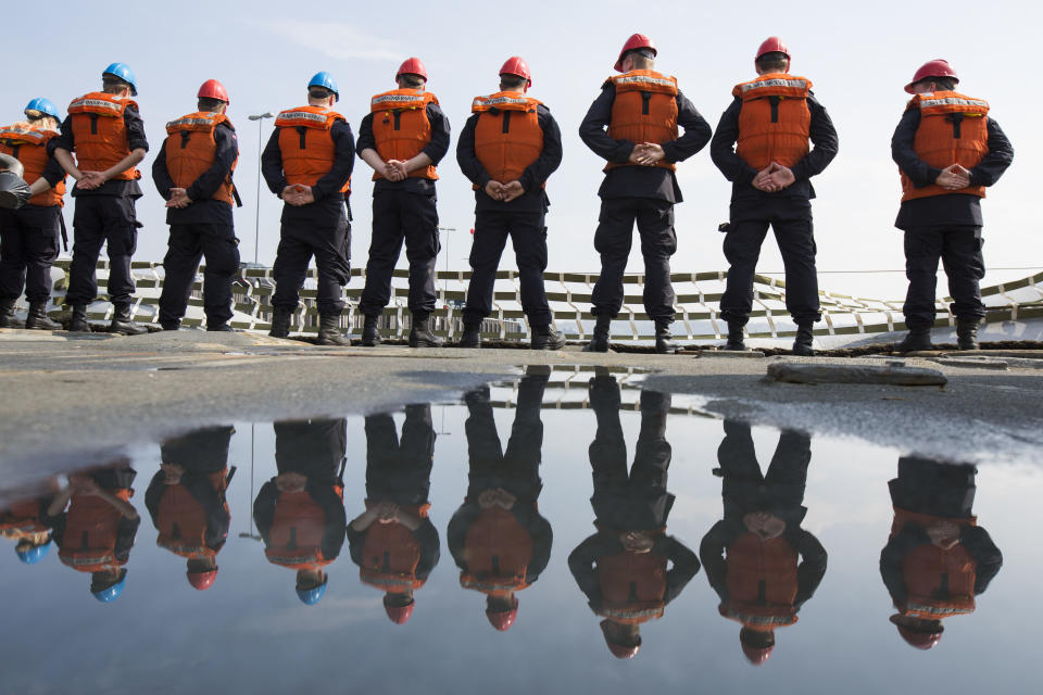 Crew members of Norwegian support vessel Valkyrien stand on board as they set sail with four other ships of Belgium, the Netherlands and Estonia from Kiel, Germany, Tuesday, April 22, 2014. The warships are part of the standing NATO Mine Counter-Measures Group ONE, one of NATO’s four standing Maritime Forces, deploying to the Baltic Sea to enhance maritime security and readiness in the region. The maritime Group was reactivated by a North Atlantic Council decision to enhance collective defense and assurance measures in response to the crisis in Ukraine. (AP Photo/Gero Breloer)