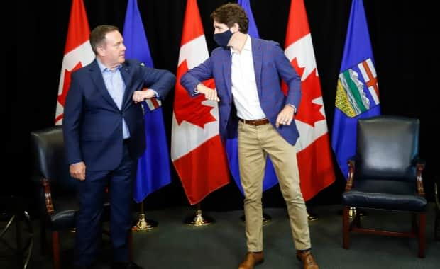 Prime Minister Justin Trudeau, right, bumps elbows with Alberta Premier Jason Kenney as the two meet in Calgary, Alta. Kenney has said Alberta won't have an internal vaccine passport program. (Jeff McIntosh/The Canadian Press - image credit)